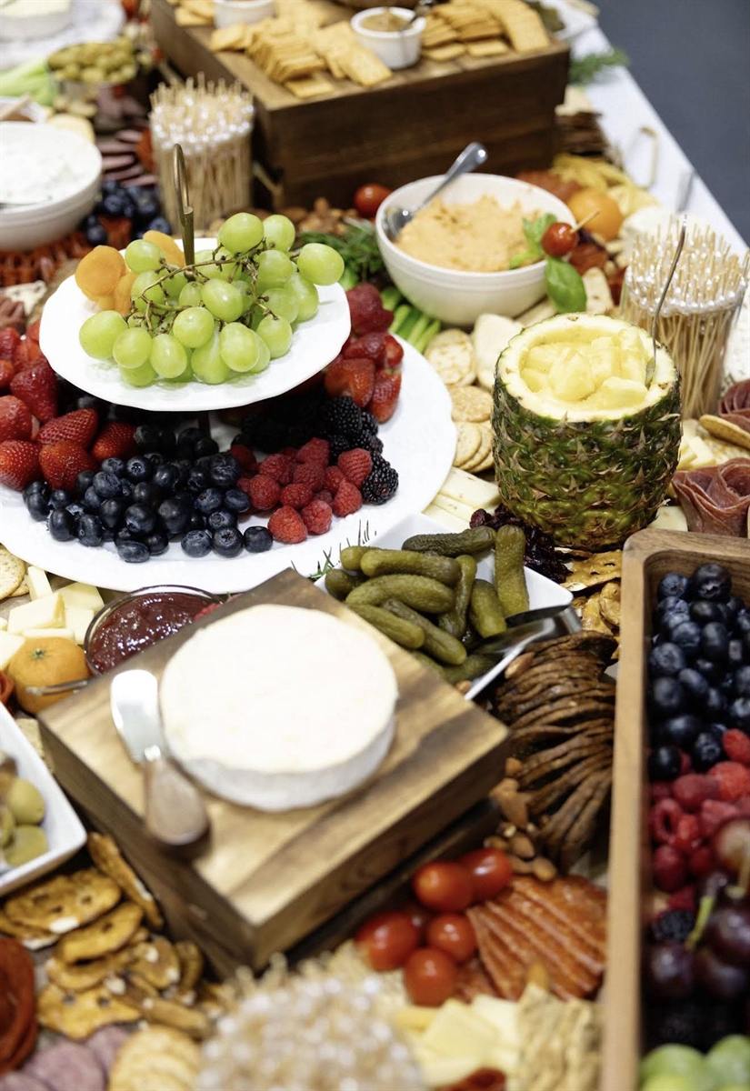 Close-up of grazing board with fruit, crackers, and cheeses